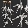 Elegant Silver Bird Shaped Chandelier With Multiple Hanging Birds Against Dark Background