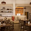 Modern Café Interior Design With Orange Arched Wall Portrait Cactus Wooden Tables And Pendant Lights