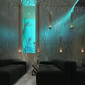 Modern Lounge Area Interior With Black Sofas Blue Lit Stone Walls And Aquarium Plants