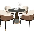 Elegant Round Black Dining Table With Four Beige Chairs Metal Legs And Decorative Vase