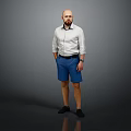 Man Standing with Hands in Pockets Wearing White Shirt and Blue Shorts Against Gray Background