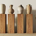 Ceramic Vases With Textured Patterns On Wooden Pedestals And Dried Flowers