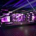 Dynamic Stage Design With Purple Green Lighting LED Screens And Geometric Lines