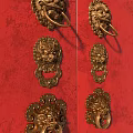 Golden Lion Head Door Knockers With Traditional Design On Red Background