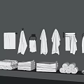White Towels Organized Hanging on Gray Wall and Stacked with Rolled Towels and Slippers on Shelf