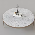 Modern Round Coffee Table With White Speckled Surface Gold Metal Legs And Diffuser On Top