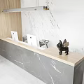 Sleek Marble Reception Desk With Two Mac Computers Black Sculpture And Long Pendant Light 3d model