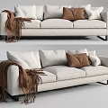 Beige Three Seater Sofa With White Brown Light Gray Cushions And Brown Tassel Blanket