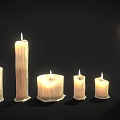 Lit Candle Lamps with Melted Wax Glowing Flames and Various Sizes Shapes on Dark Background
