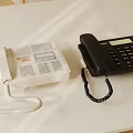 White And Black Landline Telephones With Keypad On White Office Desk