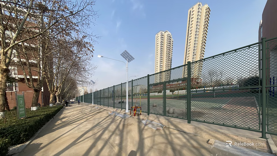 School Playground With Green Chain Link Fence Solar Street Lights Sidewalk And Blue Sky 3d model 