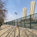 School Playground With Green Chain Link Fence Solar Street Lights Sidewalk And Blue Sky