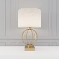 Elegant Modern Table Lamp With Fabric Shade And Brass Spherical Frame On Gray Panel Wall