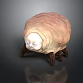 Pupa Like Sculpture With Human Face Features Legs And Bumpy Light Brown Surface
