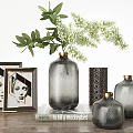 Gray Textured Vases With Gold Lids Green Foliage And White Flowers On Wooden Table