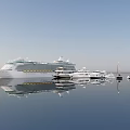 Luxury Yachts of Various Sizes Floating on Calm Blue Water With Reflections
