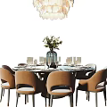 Elegant Dining Table Set With Round Black Tabletop Beige Chairs Flower Vase And Golden Decor