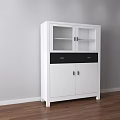 White Decorative Cabinet with Glass Doors and Drawers against Gray Wall on Wooden Floor