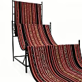 Red And Black Striped Blankets With Geometric Patterns Hanging On Black Rack