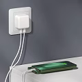 White USB Phone Charger Plugged in Wall Socket Charging Green Mobile Phone