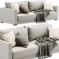 Beige Two Seater Sofa With Soft Gray And White Pillows And Warm Knitted Blanket