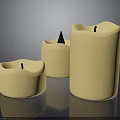 Set Of Three Cream Colored Household Candles With Various Shapes And Wicks