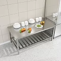 Stainless Steel Workbench In Commercial Kitchen With Plates Cups Carrots Potatoes And Vegetables