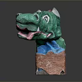 Vibrant Green Dragon Sculpture With Red Accents Lying On Brown Base Artistic