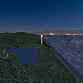 Scenic Tower On Green Hill With Lake And Distant City Lights At Night