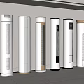 Several Modern White Tower Air Conditioner Fans with Gold Accents in Minimalist Interior