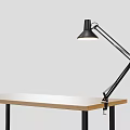 Modern Black Adjustable Arm Desk Lamp On Wooden Desk With Gray Background