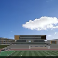 Modern School Building Exterior With Large Glass Windows Open Plaza And Greenery