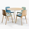 Modern Round Wooden Table With White Legs And Four Colored Upholstered Chairs