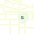 Vibrant Commercial Street with Colorful Balloons Outdoor Seating Green Plants and Pedestrians