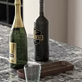 Green Champagne And Dark Wine Bottles On Marble Countertop With Brown Tray And Clear Cup