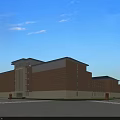 Modern School Building With Red Brick Exterior Large Glass Windows And Green Lawn