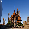 Cartoon Scene of Enchanted Castle with Spires Towers Hilltop Fountain Platform and Bridge