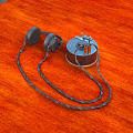 Vintage Computer Accessories With Retro Headphones And Mechanical Device On Orange Wooden Tabletop