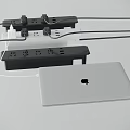 White MacBook Laptop Connected to Power Strip with Multiple Plugs and Cables