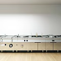 Modern Commercial Kitchen With Stainless Steel Cooking Equipment And Workstations