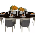 Round Dark Tabletop Dining Table and Chairs Set With Orange Flower Bouquets