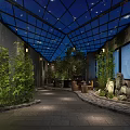 Nighttime Illuminated Indoor Courtyard With Glass Roof Stone Floor Green Plants And Lanterns
