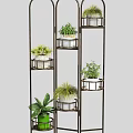 Multi Tiered Metal Plant Stand With Various Potted Plants And White Pots