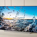 High Definition Television Showing Vibrant Water Splash Scene and Sunset Landscape