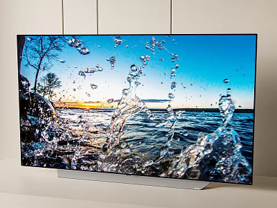 High Definition Television Showing Vibrant Water Splash Scene and Sunset Landscape 3d model