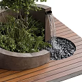 Tree Planter with Green Trees and Plants on Wooden Deck with Small Waterfall and Pebbles