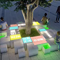Tree Pit With Colorful Seating Blocks And Illuminated Design In Urban Square