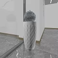 Transparent Spherical Glass Sculpture Placed On White Diamond Pattern Column With Marble Floor