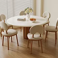 Round White Dining Table Set with Six Wood Leg Upholstered Chairs Vase Flowers Books Fruit