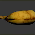 Yellow Banana With Brown Spots On Black Background And Reflected Surface